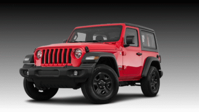 2023 Jeep Wrangler front view, iconic seven-slot grille and round headlights.