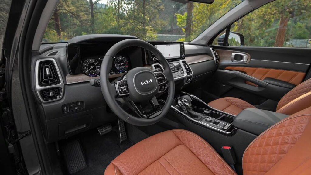 2022 Kia Sorento interior showing three rows of seating, 10.25-inch touchscreen display, quality materials, and spacious cabin configuration