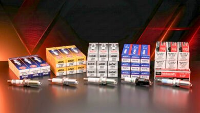 Five spark plug sets from NGK and ACDelco and Motorcraft displayed together