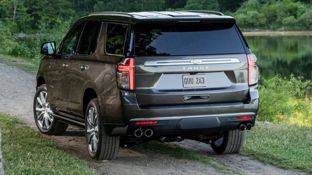 2023 Chevrolet Tahoe rear view showing full-width LED taillights, power liftgate opening, extended cargo area, dual exhaust outlets, and substantial rear overhang