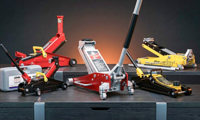 Floor jack lifting a vehicle in a home garage