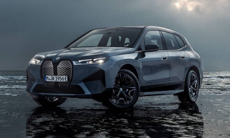 2023 BMW iX front view featuring illuminated kidney grille and futuristic electric SUV design