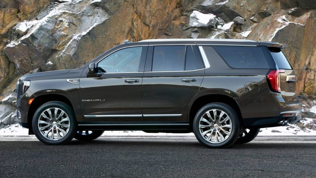 2023 GMC Yukon side profile, boxy silhouette and large wheels.