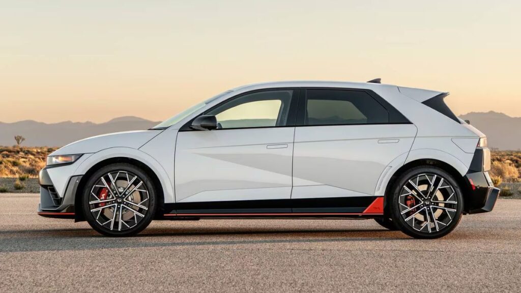 2025 Hyundai Ioniq 5 N side profile, 21-inch forged wheels and Luminous Orange accent.