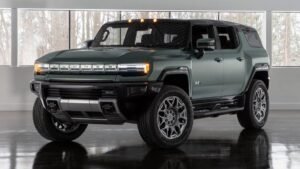 2024 GMC Hummer EV SUV front view, massive grille and LED headlights.