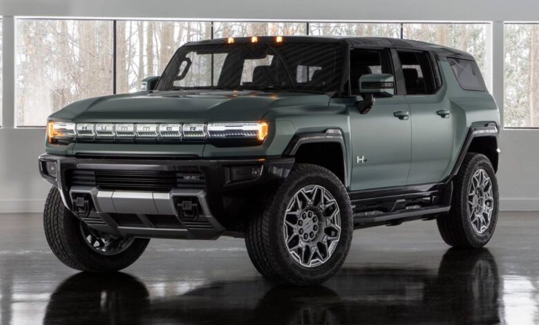 2024 GMC Hummer EV SUV front view, massive grille and LED headlights.