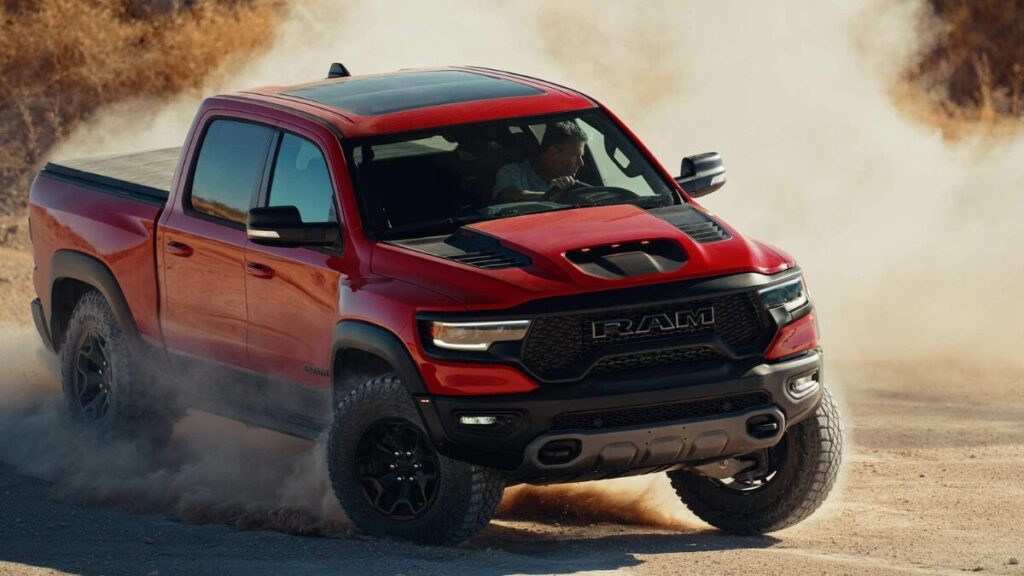 2022 RAM 1500 TRX front view showcasing the aggressive grille, hood scoop, and supercharged off-road truck design