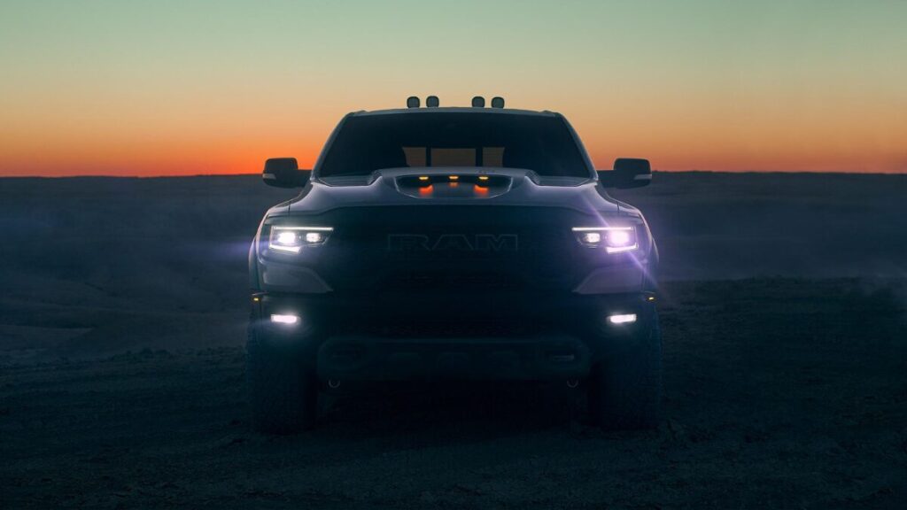 2022 RAM 1500 TRX front view showcasing the aggressive grille, hood scoop, and supercharged off-road truck design