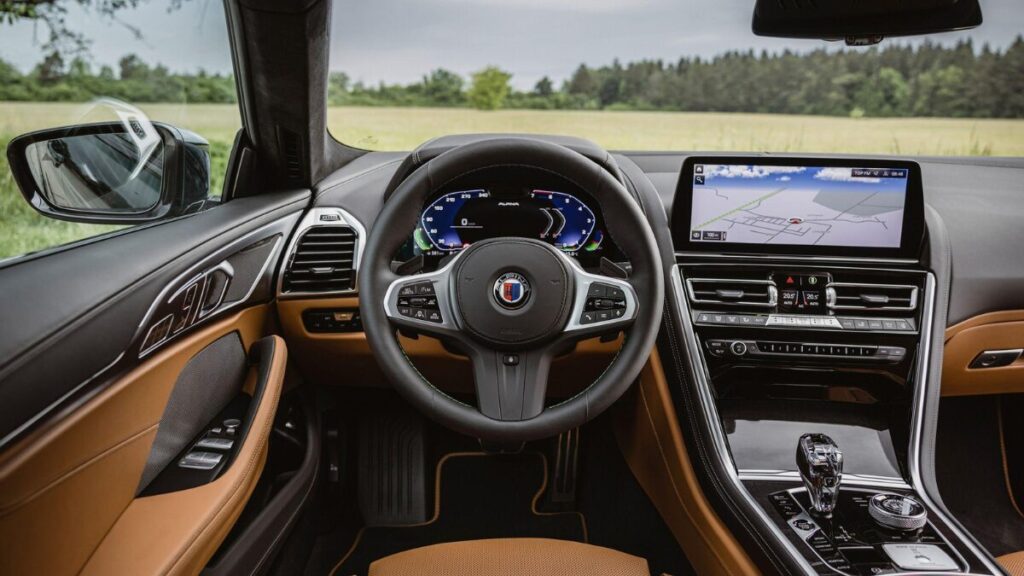 Interior view of the 2023 BMW Alpina B8 Gran Coupe featuring premium leather seats and digital displays