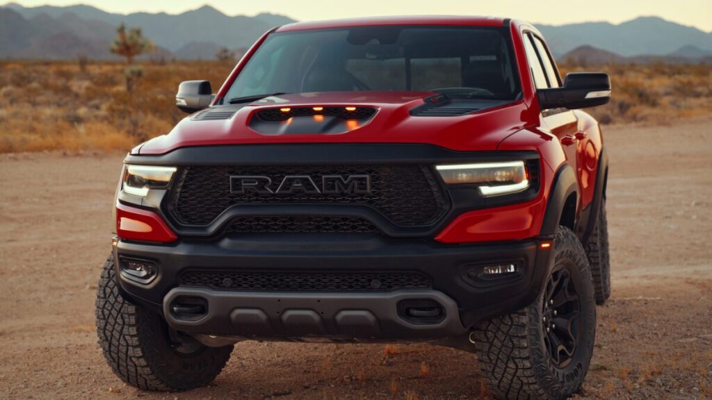 Front view of a red 2022 Ram 1500 TRX parked in the desert at sunset