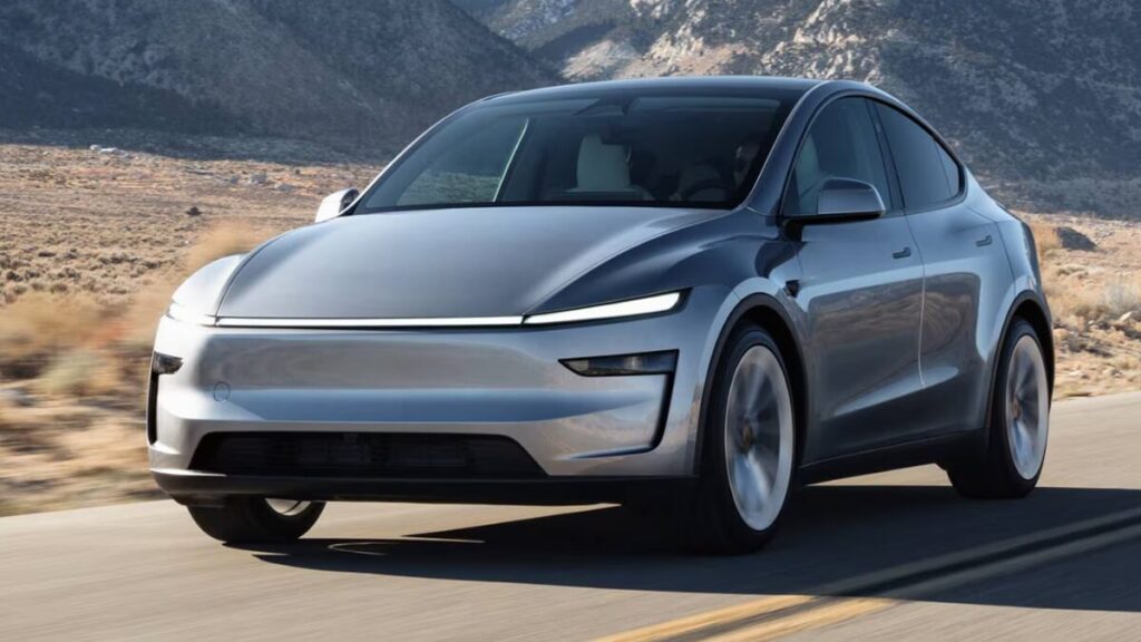 2026 Tesla Model Y driving on the road front rolling shot