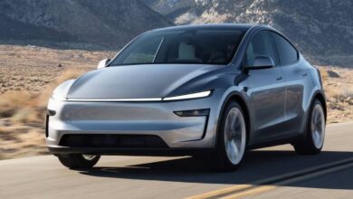 2026 Tesla Model Y driving on the road front rolling shot