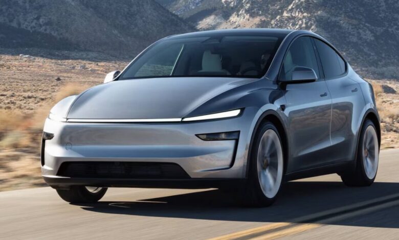2026 Tesla Model Y driving on the road front rolling shot