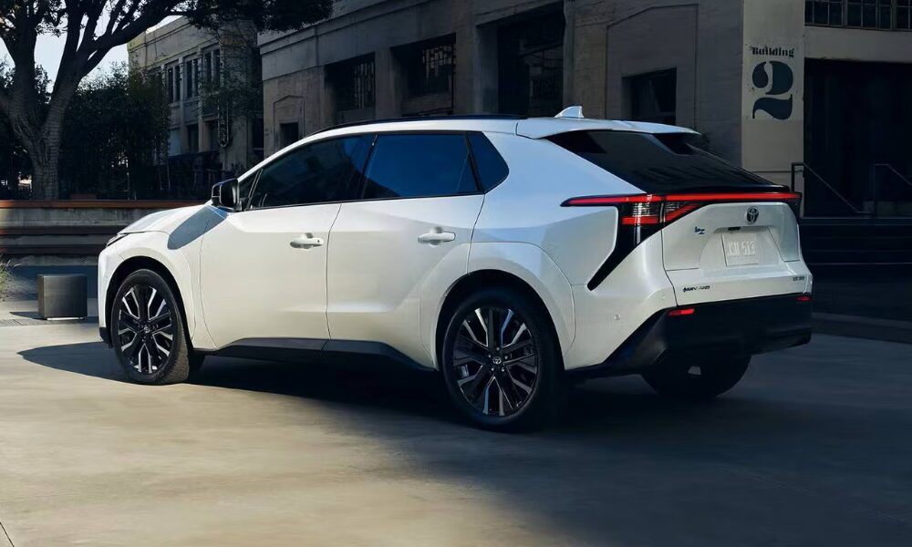 Rear-side view of 2026 Toyota bZ electric SUV with LED taillight bar and aerodynamic body design