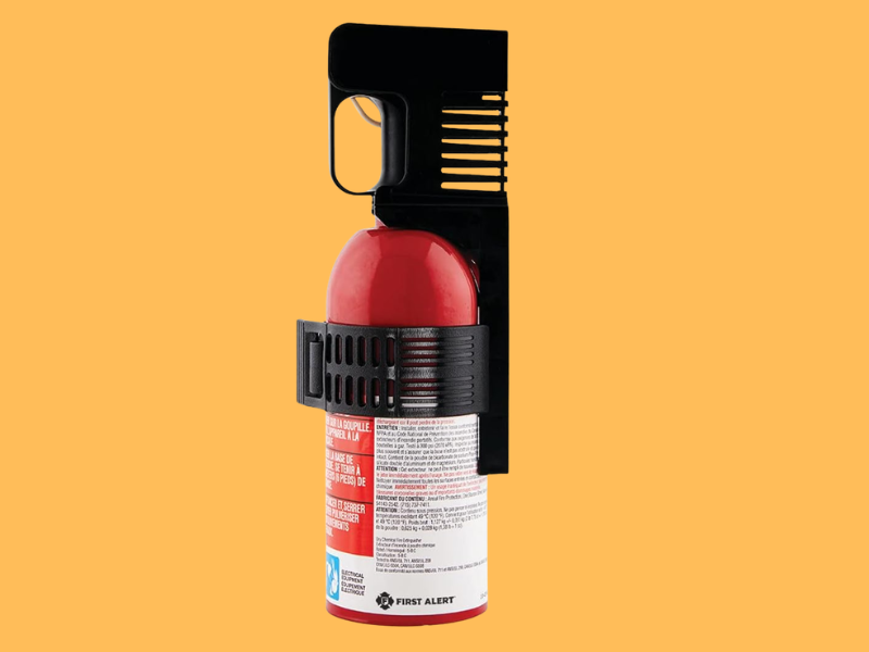 First Alert AUTO5 car fire extinguisher mounted inside a vehicle for emergency fire protection
