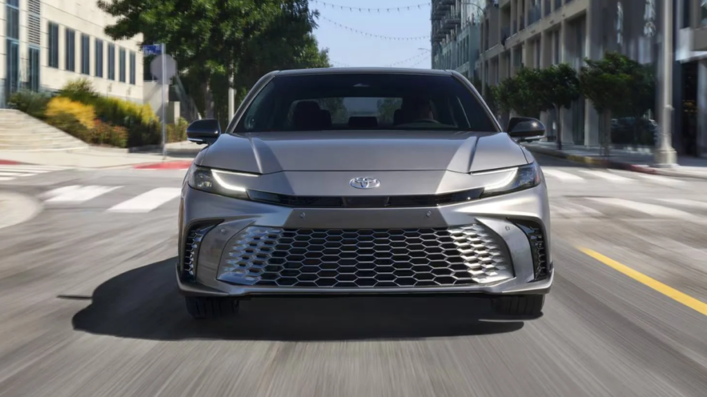 2026 Toyota Camry driving on the road viewed from the front